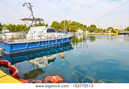 boats reflected on sea at Eleusis harbor Greece
