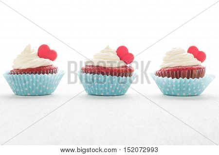 Red velvet heart cupcakes with cream cheese frosting and a red heart for Valentine's Day