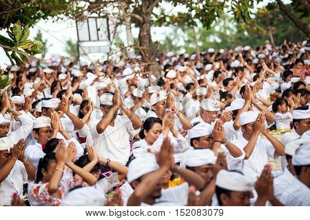 BALI, Indonesia - MAR 9, 2013: Local people during performed Melasti Ritual. Melasti is a Hindu Balinese purification ceremony and ritual is held several days prior to the Nyepi holy day.