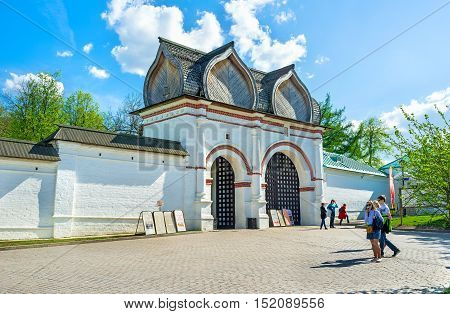 MOSCOW RUSSIA - MAY 10 2015: The white Spassky Rear Gate with the figured wooden roof leads to the Kolomenskoye Royal Estate on May 10 in Moscow.