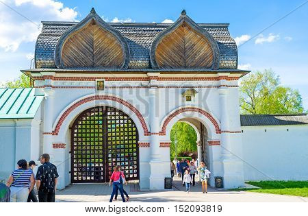 MOSCOW RUSSIA - MAY 10 2015: The tourists walks through the Spassky Rear Gate leading to the Kolomenskoye Royal Estate on May 10 in Moscow.