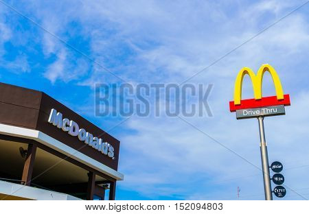 Khonkaen Province, Thailand - December 20, 2015 : McDonalds logo on blue sky McDonald's Corporation is the world's largest chain of hamburger fast food restaurants.