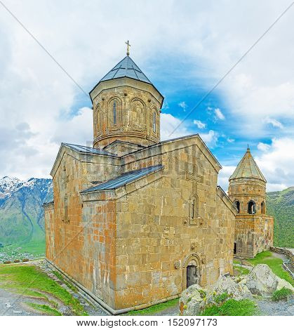 The wall of Tsminda Sameba (Holy Trinity) Church is the medieval stone church with carved decors and gate chapel located at the foot of Kazbek Mount Gergeti Georgia.