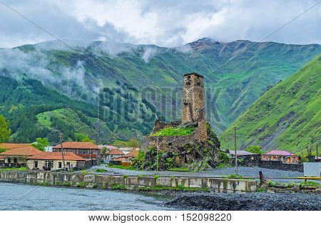 The ruins of the medieval castle of Sno village with high stone tower built at the bank of Snostskali river Georgia.