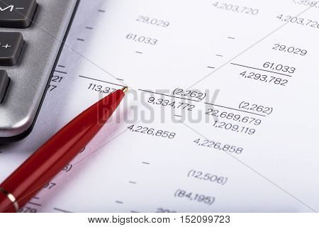 Caclulator and Pen on the Financial Document - Close Up