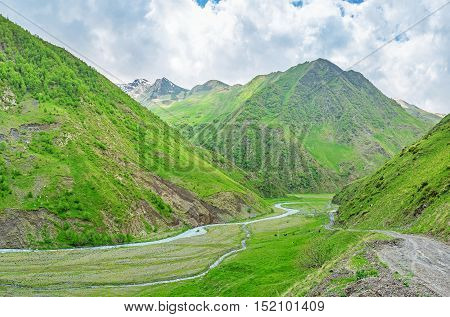 The green Juta valley with the fast flowing Jutistskali river and cloudy weather Georgia.