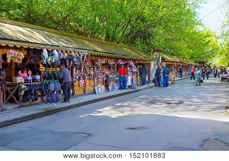 MOSCOW RUSSIA - MAY 10 2015: The wooden stalls of Izmailovsky market with the wide range of souvenirs art and craft goods antiques and others on May 10 in Moscow.