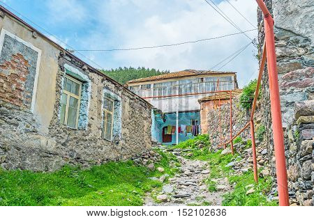 The old stone residential house on the mountain with the narrow stone path Stepantsminda Georgia.