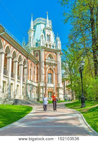 MOSCOW RUSSIA - MAY 10 2015: The Gothic tower of the Grand Palace of Imperial Residence in Tsaritsyno surrounded by shady trees on May 10 in Moscow.