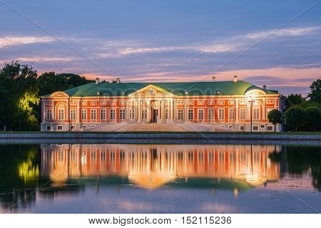 MOSCOW RUSSIA - JUNE 13 2015: Night view of the Kuskovo park. Kuskovo Palace and reflection in pond. Kuskovo was the summer country house and estate of the Sheremetev family. Moscow Russia.