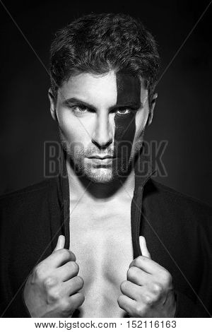Portrait of a handsome young man in body painting