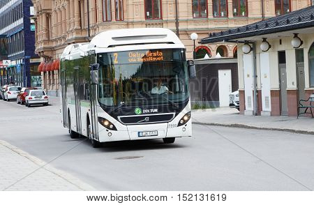 Sundsvall, Sweden - May 30, 2016: One white public transport city bus in downtown Sundsval in trafic on line number 2.l