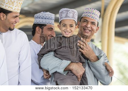 Niawa Oman October 13th 2016: father and son at Nizwa Goat market