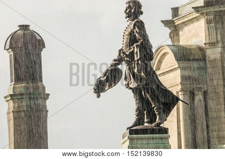 Quebec City, Canada - July 27, 2014: Champlain Monument statue on Dufferin Terrace in sunlight during rain