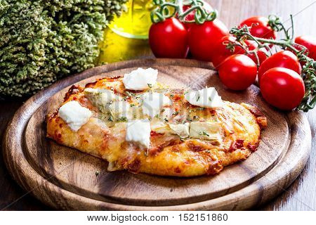 Pizza With Artichoke And Oregan On Wood