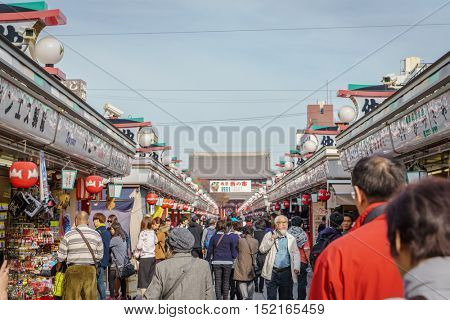TOKYO,JAPAN - 24 November  2015 :Tourists walk on Nakamise Dori in Sensoji shrine.Sensoji temple with a variety of traditional, local snacks and tourist souvenirs for centuries.