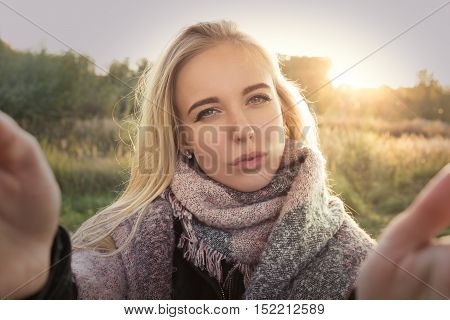 fun girl taking selfie with duckface at sunset time