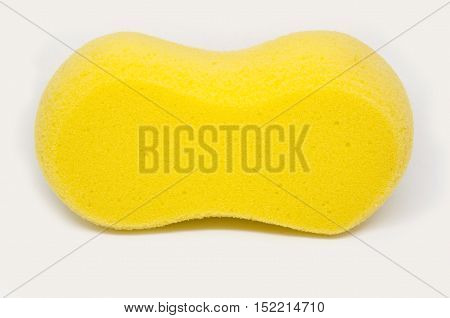 Sponge over white background. Yellow household cleaning sponge.