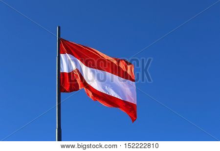 Great Austrian Flag Waving In The Blue Cloudless Sky