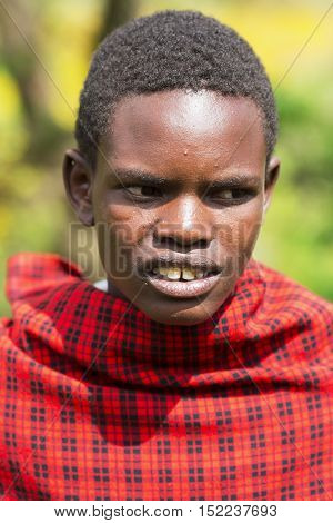 AFRICA, KENYA, MAY, 08, 2016 - Maasai Mara tribe men in a red cape at Maasai Mara National Park, Kenya, Africa.  The Maasai (sometimes spelled Masai) are a Nilotic ethnic group of semi-nomadic people inhabiting southern Kenya and northern Tanzania.