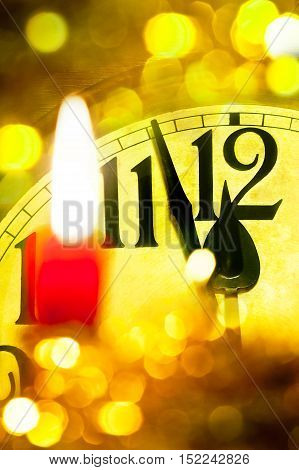 Detail of new year clock with flaming candle