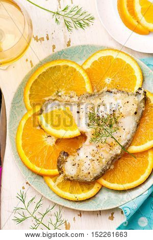 Orange Halibut Steaks on blue plate.seletive focus