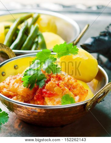 Poached Fish in Tomato Sauce. seletive focus