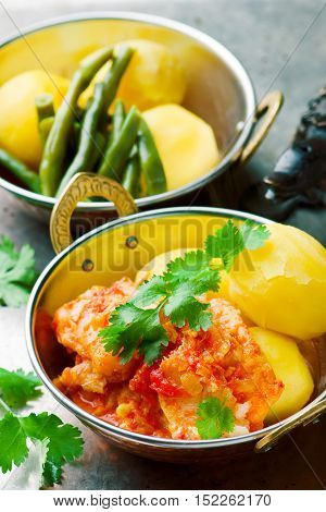 Poached Fish in Tomato Sauce. seletive focus