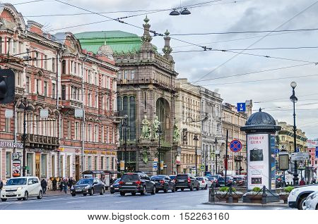 Saint Petersburg Russia - September 25 2016: The view of Nevsky Prospect with its afternoon rush hour traffic as seen from Sadovaya Street with Elisseeff Emporium a famous food hall one of the most striking examples of Art Nouveau style in a typical rainy