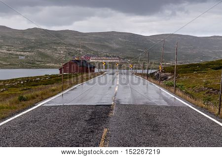 Winding mountain road with snow levels in Norway