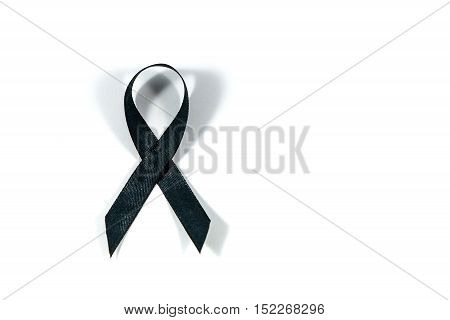 Black awareness ribbon isolated on white background. Mourning and melanoma symbol