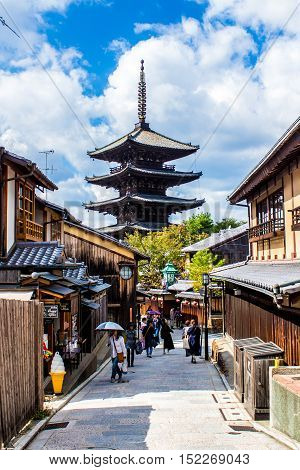 KYOTO JAPAN - OCTOBER 14 2015 - People walking in higashiyama the old streets of Kyoto with Yasaka pagoda in the background