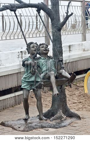 RUSSIA ZELENOGRADSK - OCTOBER 11 2014: Sculpture of children playing in the Zelenogradsk promenade. Zelenogradsk (Cranz) is a resort town in Kaliningrad Oblast Russia near the Curonian Spit on the Baltic Sea.