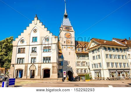 View on the city gate and clock tower in Zug town near Zurich city in Switzerland
