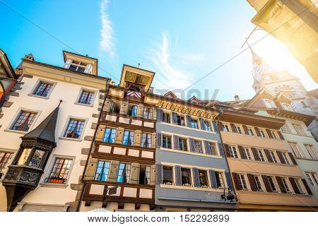Beautiful colorful buildings with clock tower in Zug village near Zurich city in Switzerland. Typical historical swiss architecture