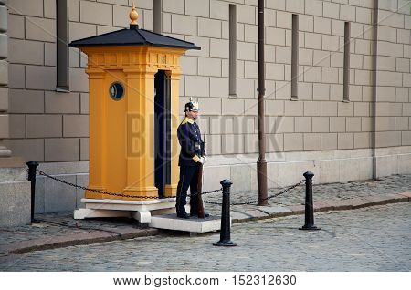 Stockholm Sweden - June 20 2012: A soldier of the Royal Guards at the Royal Palace in Stockholm in front of yellow sentry box.