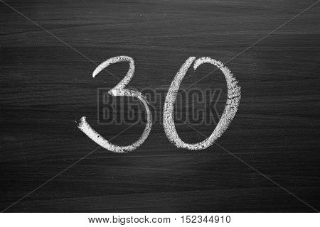 number thirty enumeration written with a chalk on the blackboard