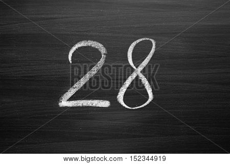 number twenty eight enumeration written with a chalk on the blackboard