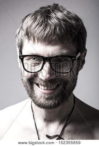 bearded man in glasses plays the fool. crazy man, funny expression.