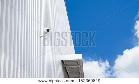 CCTV surveillance security camera video equipment in factory warehouse and industrial building on wall for safety system area control outdoor with copyspace