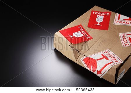damaged cardboard box with fragile sticker
