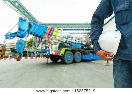 The engineering and safety helmets stood on the details of Industrial Crane operating and lifting