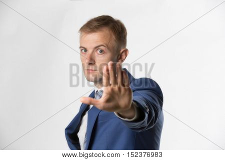 Businessman holding hand up and saying Stop