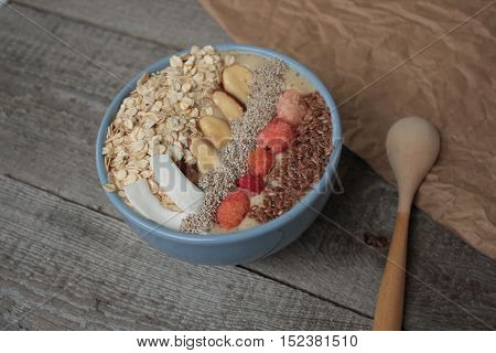 Breakfast berry smoothie bowl topped with raspberries, Chia, flax seeds, coconut, Brazil nut