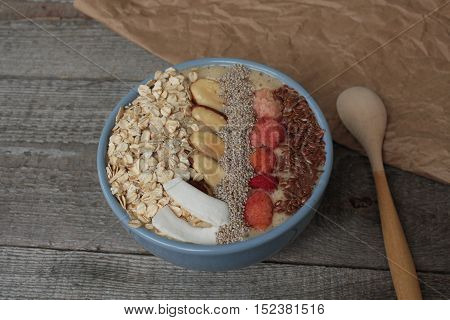 Breakfast berry smoothie bowl topped with raspberries, Chia, flax seeds, coconut, Brazil nut