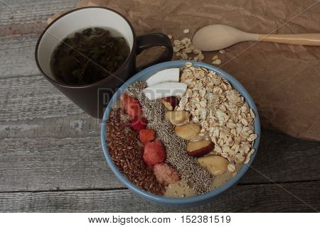 Breakfast berry smoothie bowl topped with raspberries, Chia, flax seeds, coconut, Brazil nut