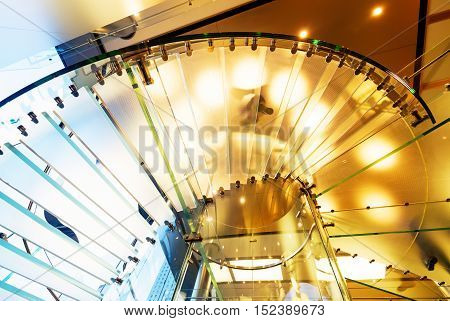 modern glass spiral staircase in shop with motion step