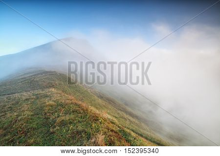 morning fog around mountaintop in Alps Austria