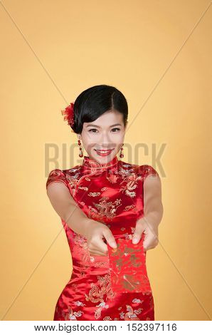 pretty chinese young woman holding red pocket for happy chinese new year