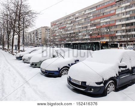 Bucharest Romania 5 January 2016: Cars covered in snow are seen parked after a snowfall in Bucharest.